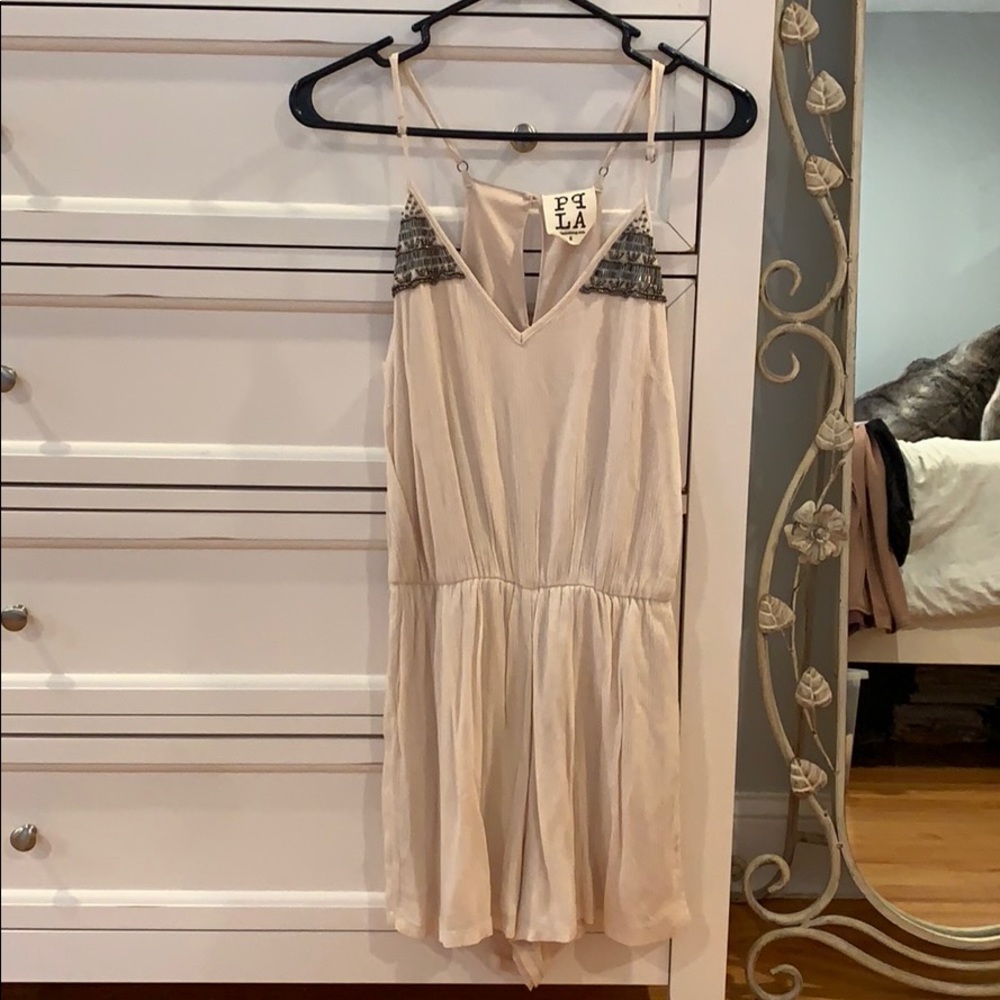 cream romper with silver beaded detail